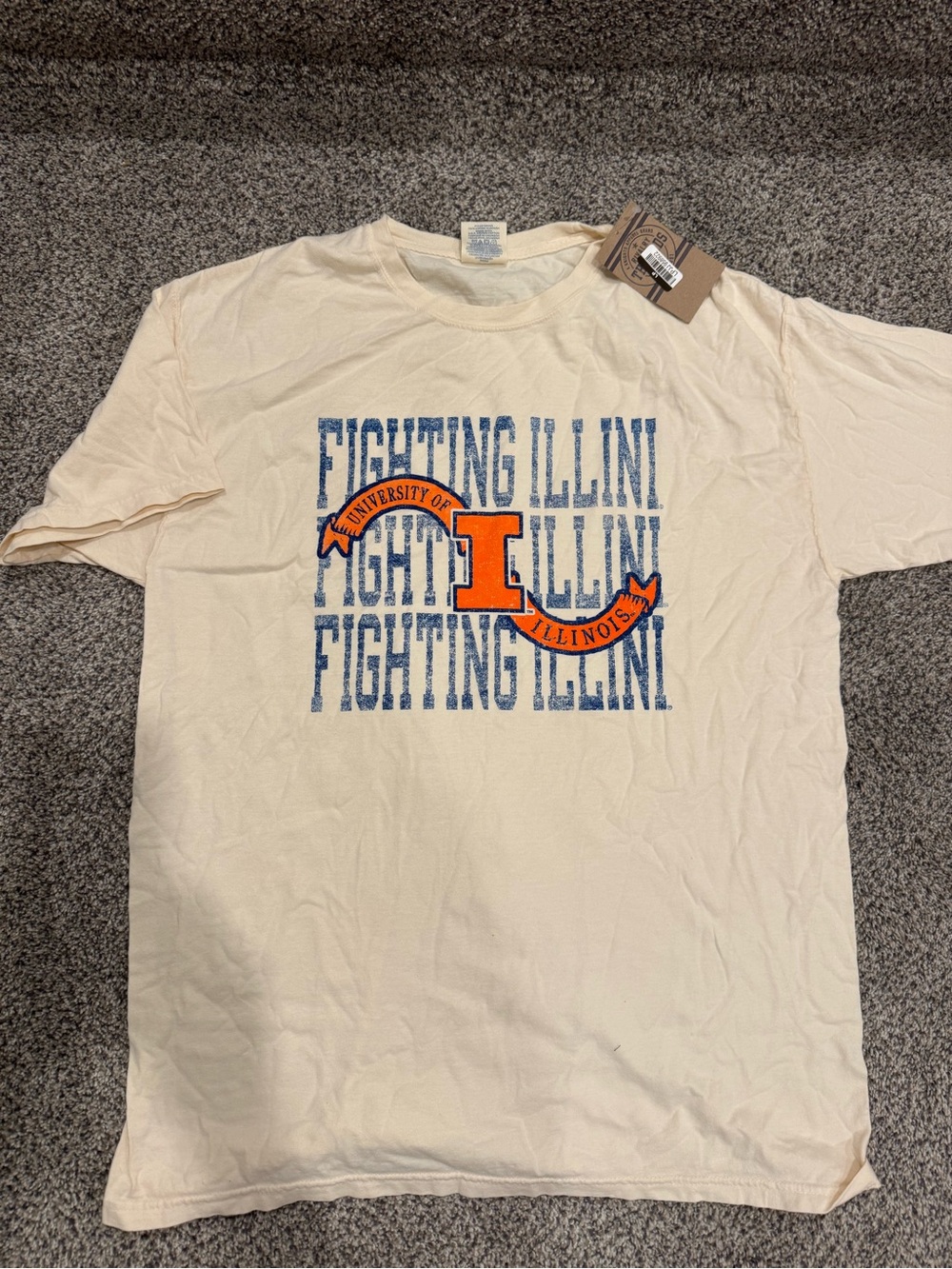 Rivalry Threads Cream100% Cotton Short Sleeve Tee with Blue Text and Orange Logo